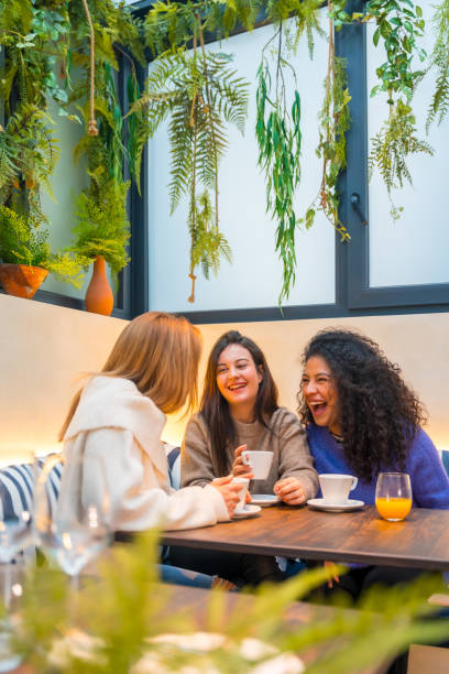 Friends having fun laughing in a cafeteria