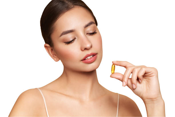 istock Beautiful Girl With Pill With Cod Liver Oil Omega-3 1954252808