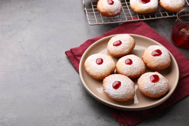 istock Hanukkah donuts with jelly and powdered sugar on grey table, space for text 1954253883
