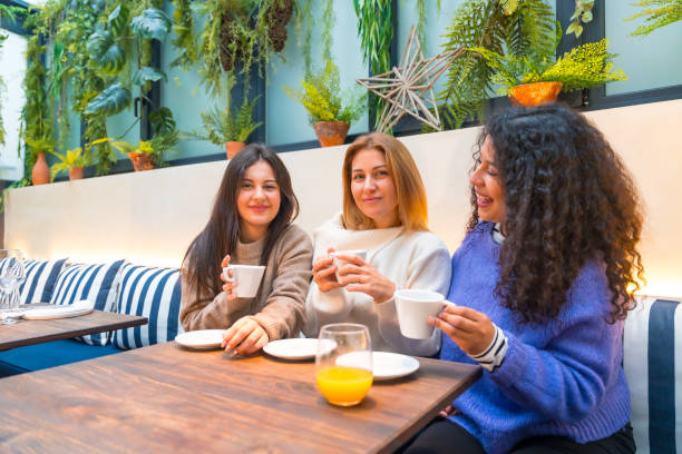 istock Three diverse woman chilling and talking in a cafeteria 1954257103