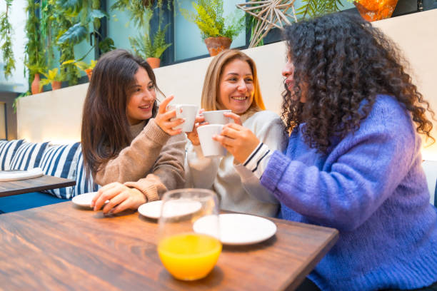 istock Women talking happily in a colorful cafeteria 1954257106