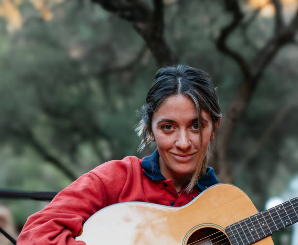 istock Girl playing the guitar in a fireplace 1954261376