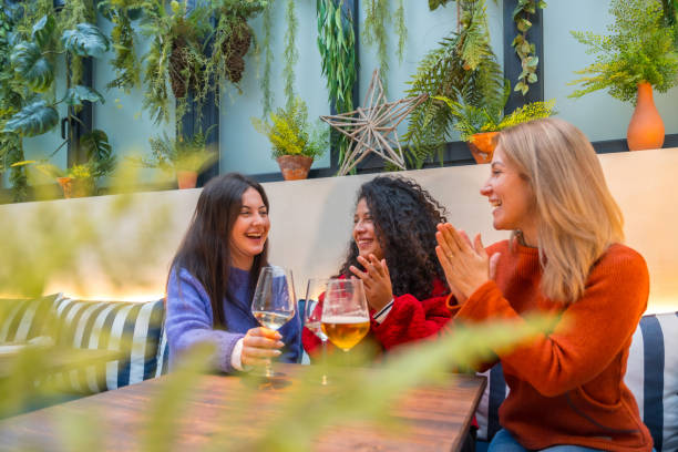istock Women applauding a celebrating with wine in a cafeteria 1954261388