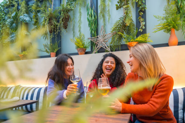 istock Women having fun drinking wine in a cafeteria 1954261389