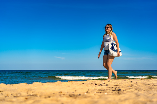 Beautiful woman walking on beach