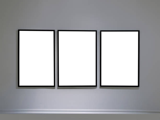istock Three empty vertical picture frames hanging on white wall, Wall art mockup set of 3 posters, blank space frame modern interior style, minimalist with clipping path 1954264211