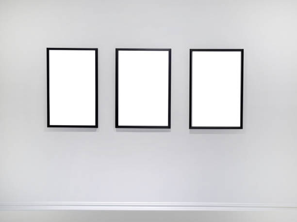 istock Three empty vertical picture frames hanging on white wall, Wall art mockup set of 3 posters, blank space frame modern interior style, minimalist with clipping path 1954264242