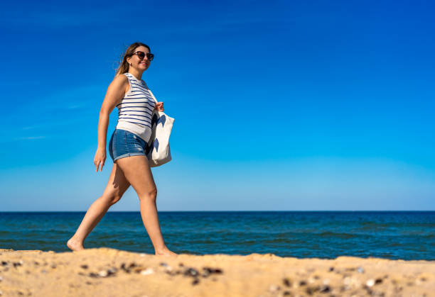 Beautiful woman walking on beach
