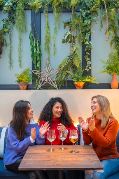 istock Women celebrating while drinking wine in a restaurant 1954265818