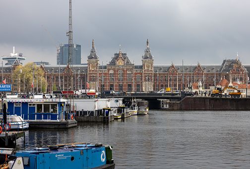 Amsterdam, Netherlands - April 21, 2023:  Central station on Damrak street in Amsterdam.