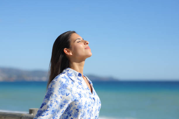 istock Woman breathing and relaxing on the beach 1954277806