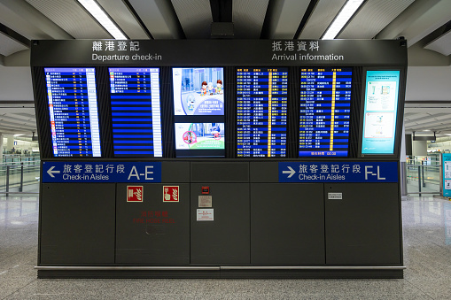 Hong Kong - September 1, 2023 : Departure check-in and arrival information board at the Hong Kong International Airport.