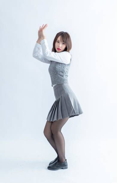istock Asian school girl dancing in a white background studio 1954290462