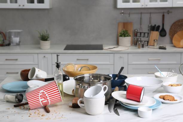 istock Many dirty utensils, dishware and food leftovers on white table. Mess in kitchen 1954296980