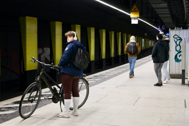 Frankfurt am Main, Germany, January 20, 2024, Woman with a bicycle on a train platform.