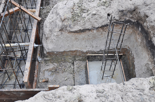 The construction of a  brick house concrete foundation, footing with plain mesh, reinforcement of a column.