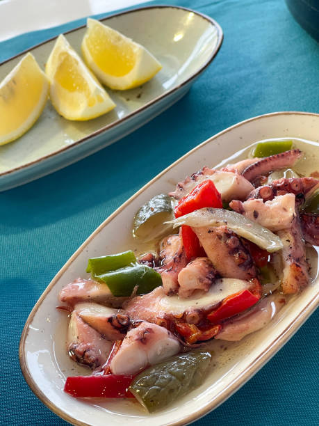 istock Fresh octopus salad with lemon wedges on ceramic plates, mediterranean cuisine 1954332295