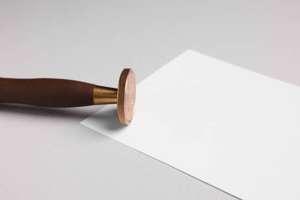 istock One stamp tool and sheet of paper on light grey background, closeup. Space for text 1954332841