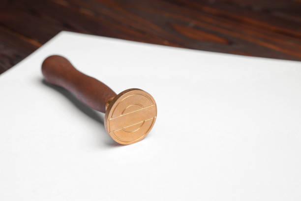 One stamp tool and sheet of paper on table, closeup. Space for text