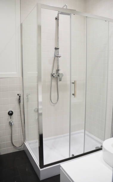 istock A close-up of a modern rectangular shower enclosure, cubicle, cabin with a shower head and a bidet shower in a black and white tiled bathroom. 1954335003