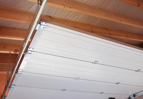 Garage door under construction. A close-up of a sectional garage door installation.