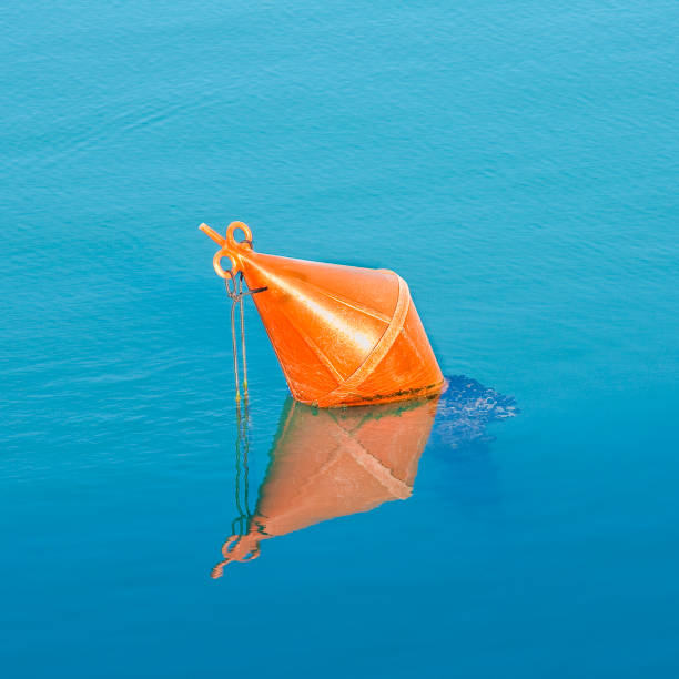 istock Plastic red bouy on a calm lake isolated on blue background 1954350652