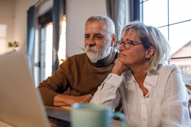 istock Mature couple choosing their next vacation destination online 1954361257