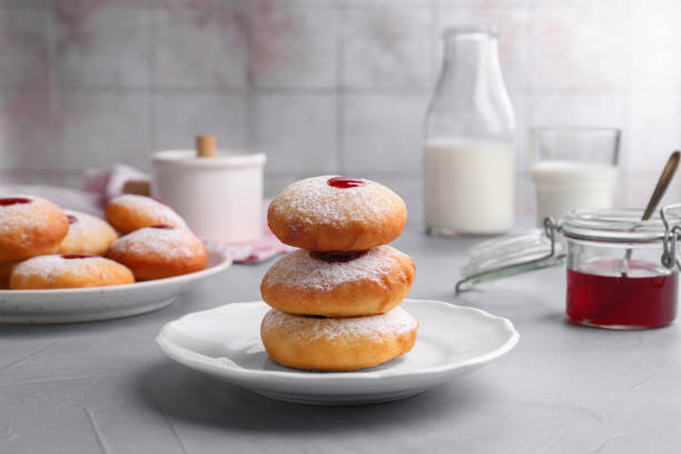 istock Hanukkah donuts with jelly and powdered sugar served on light grey table 1954361735