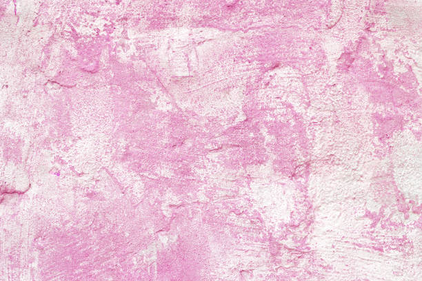 Vintage, old stucco plaster surface background, close up rough texture of pink and white mixed color painted cement, concrete wall texture. Wallpaper, backdrop, architecture design element