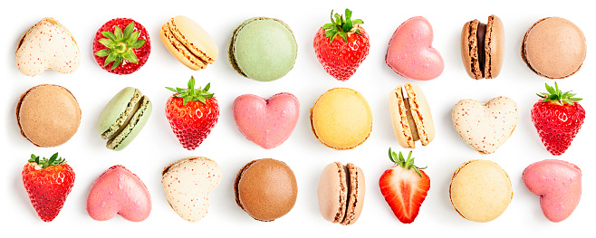 Macaroons, strawberry fruit and macaron hearts collection isolated on white background. Holiday greeting card. Valentine concept. Design element. Creative layout. Flat lay, top view
