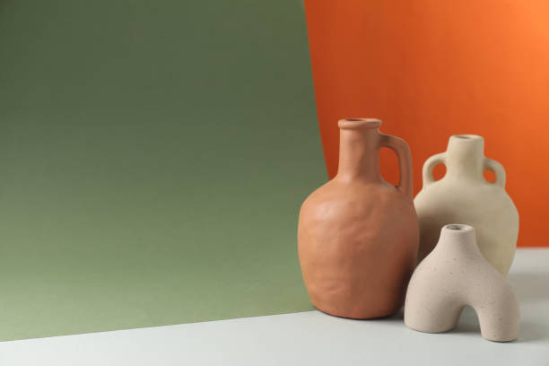 istock Clay flagons and vase on color background, space for text 1954362232