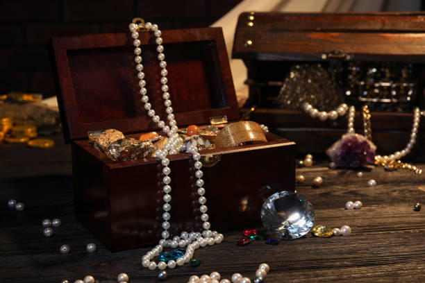 istock Wooden chests with treasures on dark floor 1954362454