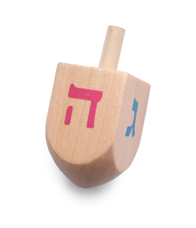 Wooden dreidel isolated on white, above view. Traditional Hanukkah game