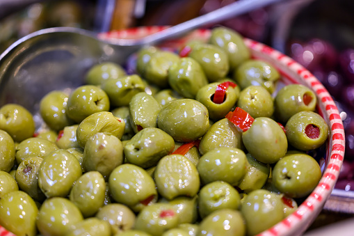 Stuffed green olives in an old wooden bowl