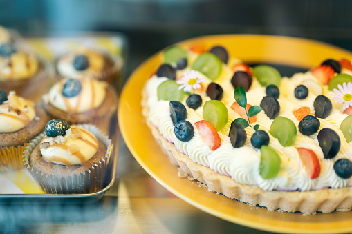 Asia Tasty fruity tartlets or cake with fresh milk cream cheese and different berries in cafe