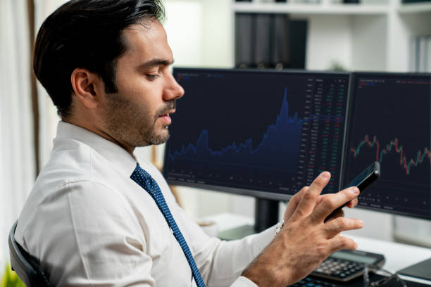 istock Trader businessman searching on smartphone, analyzing in dynamic stock. Surmise. 1954426480