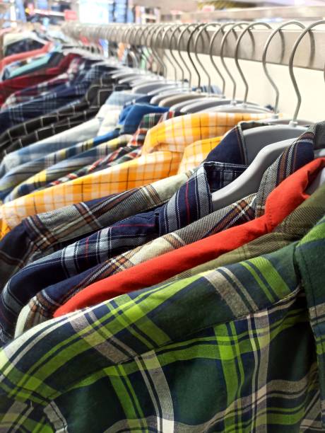 Multi colored check pattern casual shirt collection Multi colored checkered pattern casual shirts collection close-up image at clothing store displayed for sale colorful check shirts on sale at a clothing store stock pictures, royalty-free photos & images