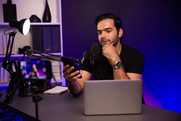 istock Broadcaster talking to listener on live streaming with blurred screen. Surmise. 1954442214