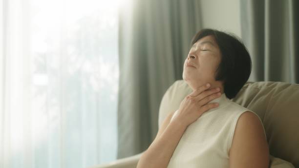 istock Woman having sore throat. 1954445435