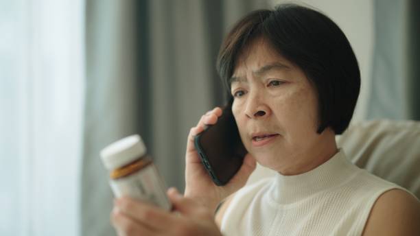istock Woman talking phone with her doctor about medication. 1954445977
