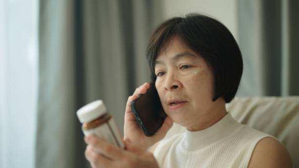 istock Woman talking phone with her doctor about medication. 1954445995