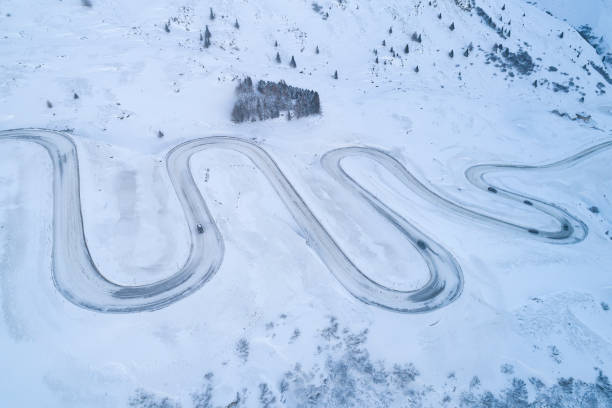 istock Snowy, winding road, aerial view 1954459055