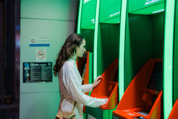 istock Woman getting cash from  ATM 1954463462