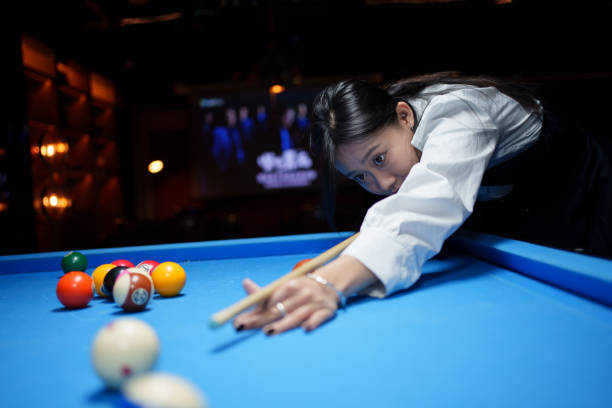 istock young woman playing billiards 1954465193