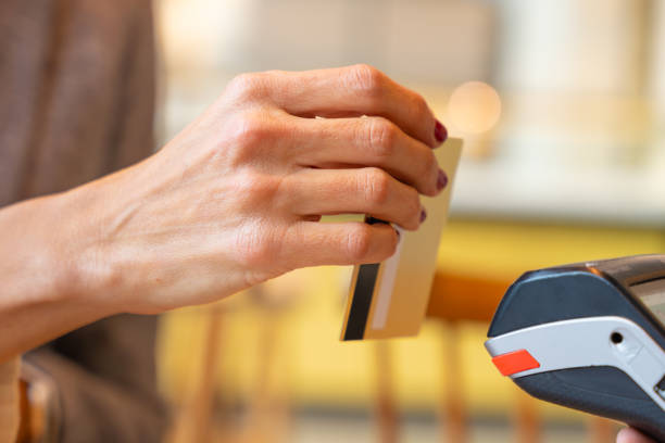 istock Customer paying with contactless credit card in a store. 1954468381