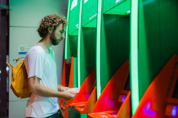 istock Man getting cash from  ATM 1954474434