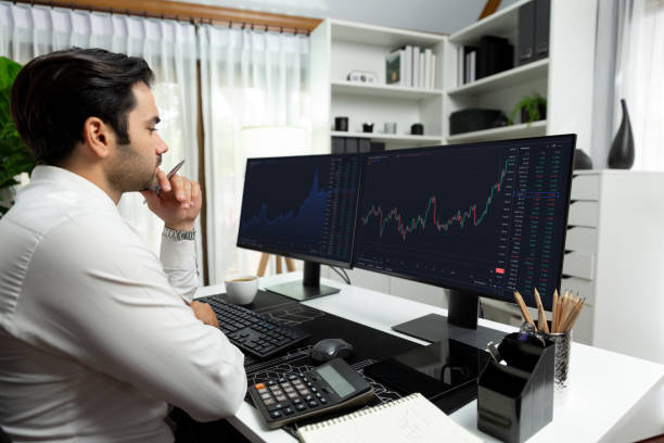 istock Trader analyzing in dynamic stock exchange investment screen on pc. Surmise. 1954482405
