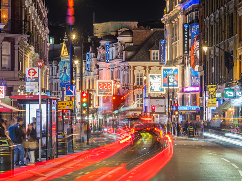 London, England - May 12, 2016: a black cab taxi crosses the iconic video advertising billboards of Piccadilly Circus, a famous public space in London's West End that was built in 1819 to join Regent Street with shopping Piccadilly Street