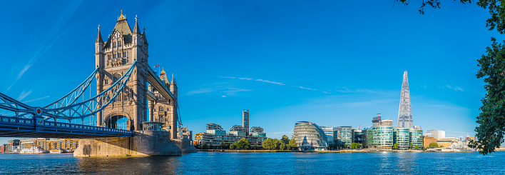 Tower Bridge across the River Thames overlooking the south bank toward the iconic spire of The Shard in central London, UK.