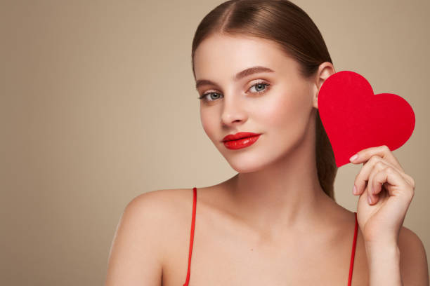 istock Beautiful woman holding an artificial red heart 1954495576